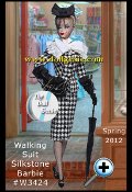 Barbie Fashion Model Collection is returning to its roots and celebrating high-fashion couture with the theme Atelier. Walking Suit Barbie is stylishly attired for a day out and about in a black-and-white houndstooth checked suit reminiscent of the 1950s. The fitted pencil skirt and jacket with shawl collar are accented with a row of small black buttons that runs down the front of each garment. A white shirt with upturned collar and sheer white bow with frayed ends dresses her neck. Stockings, black gloves, black pointy-toed shoes and a black hat with netting add sophisticated touches. This Barbie also has a black handbag and black umbrella. 6,600 worldwide